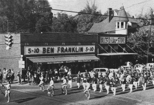 Montevallo High School band leads the Homecoming parade through the Main and Middle St. intersection in 1963. The Kroell house in the background was still standing when this photo was taken