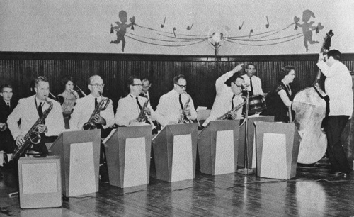 The "Kiwanians" a dance band from Columbiana plays for the Montevallo High School Valentine dance in 1964. Mike Mahan of Montevallo plays the stand-up bass. Among the sax players on the front row are, (left-right) Conrad Fowler, Shelby County Probate Judge; unknown, Dr. John W. Stewart, future chairman of the University of Montevallo music department and future President of the University of Montevallo; prominent Shelby County attorney, Wales Wallace; unknown.