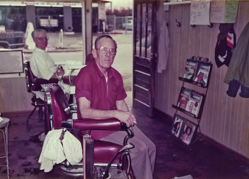 Ottis Bean (left) and Raymond Bearden in 1984 in their small barber shop on MIddle Street. The small boys' chair can be seen between the two adult chairs.