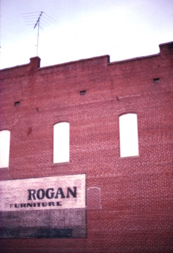 Rogan Furniture at the corner of Main and Shelby Streets. Close scrutiny of the sign reveals the words "Funeral Director and Ambulance Service." Rogan was one of the town's undertakers for many years.