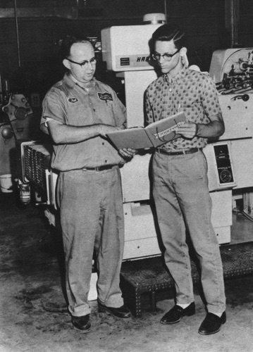 Pat Wyatt with Lee Barclay, Jr., editor of the 1961 edition of the Montevallo High School yearbook, Montala. Times printed the yearbook on the Harris offset press behind them.