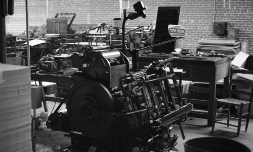 Letterpresses in the Times Printing pressroom, 1972. In the foreground is a Heidelberg "Windmill" press. It gets its name from the way the two feeder arms spin around like a windmill as sheets of paper are fed into the press and removed after printing into a delivery pile. This excellent German press was used for envelopes, business cards, letterheads, and form numbering jobs. In the background to the left is a Kelly Automatic cylinder letterpress. This press had been at the old shop in the Masonic building basement and had been used for fine quality book work. By 1972 it was used primarily for printing "reproduction proofs" for the offset department. To the right of the Kelly is the big Huber that also came from the old shop.